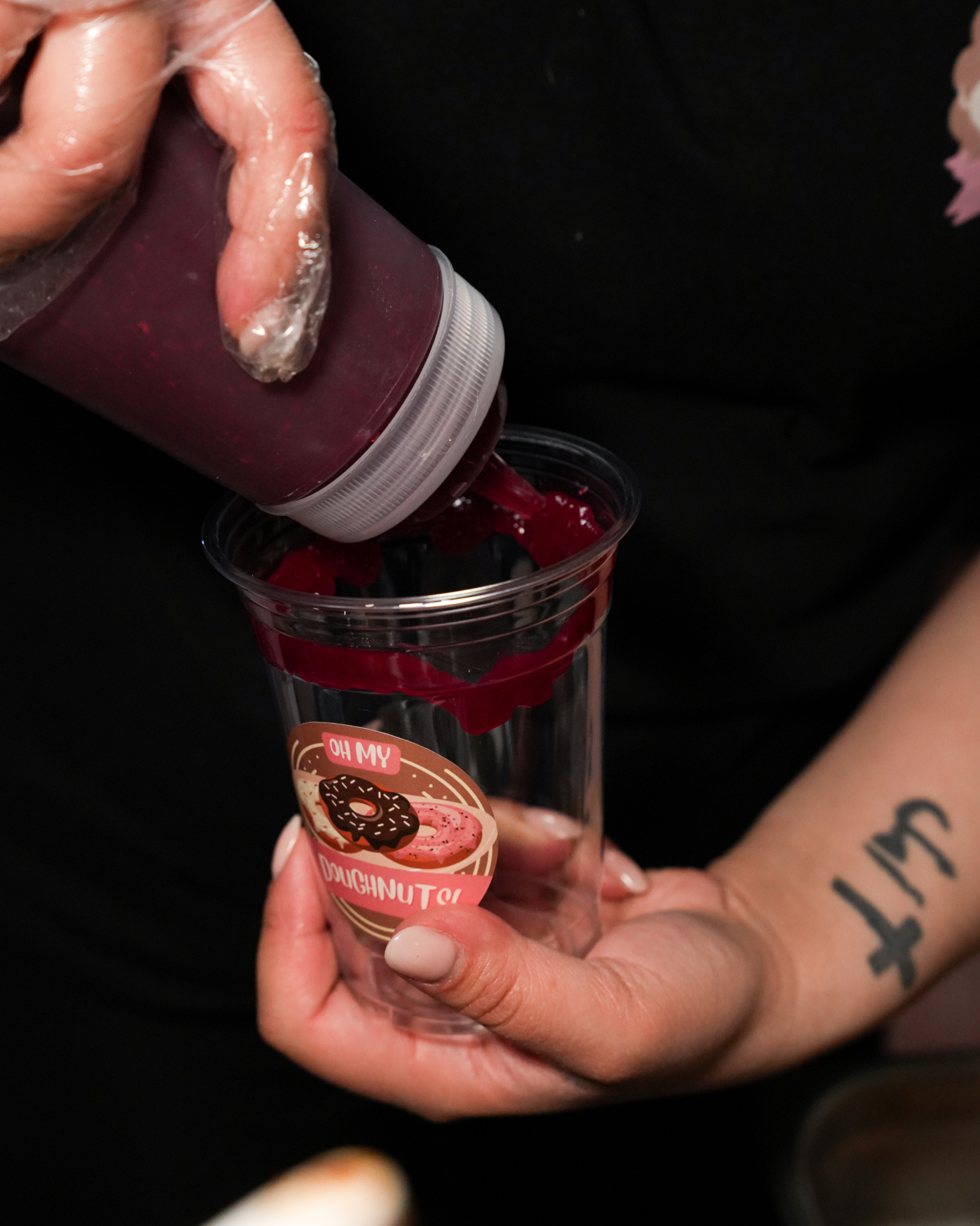 Berry sauce poured into a branded cup