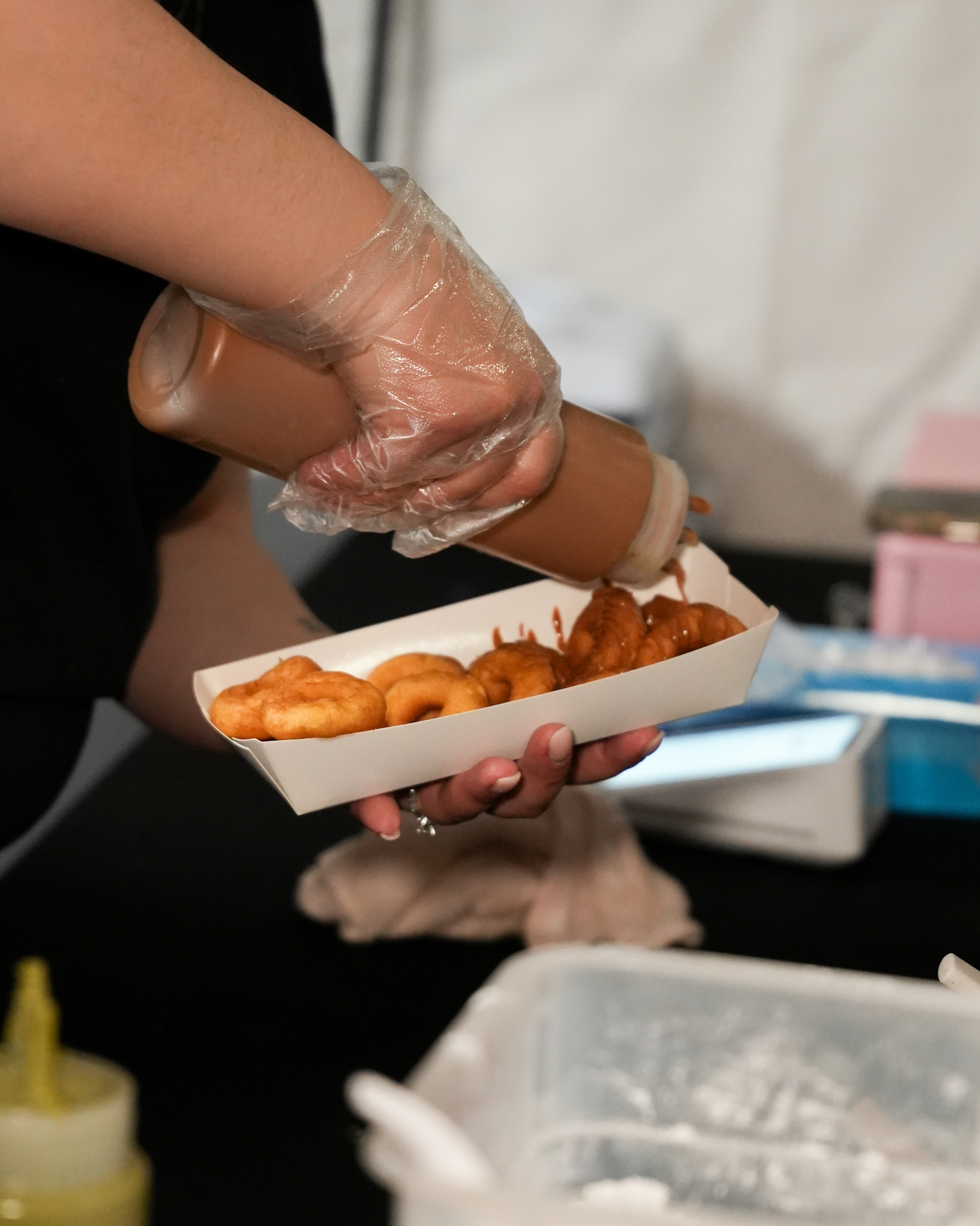 Caramel mini doughnut tray at an outdoor market