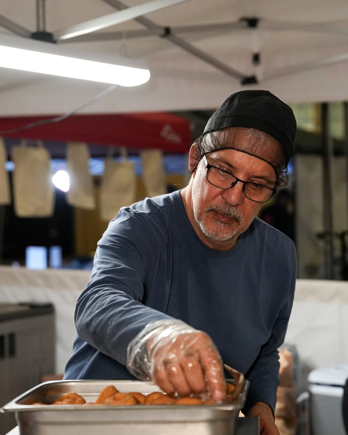Chef serving fresh doughnuts to a guest