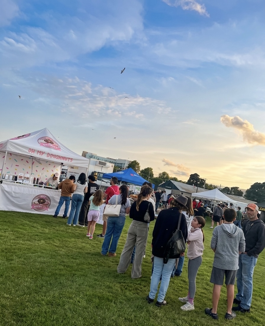 Crowd around the Oh My Doughnuts stand at a market