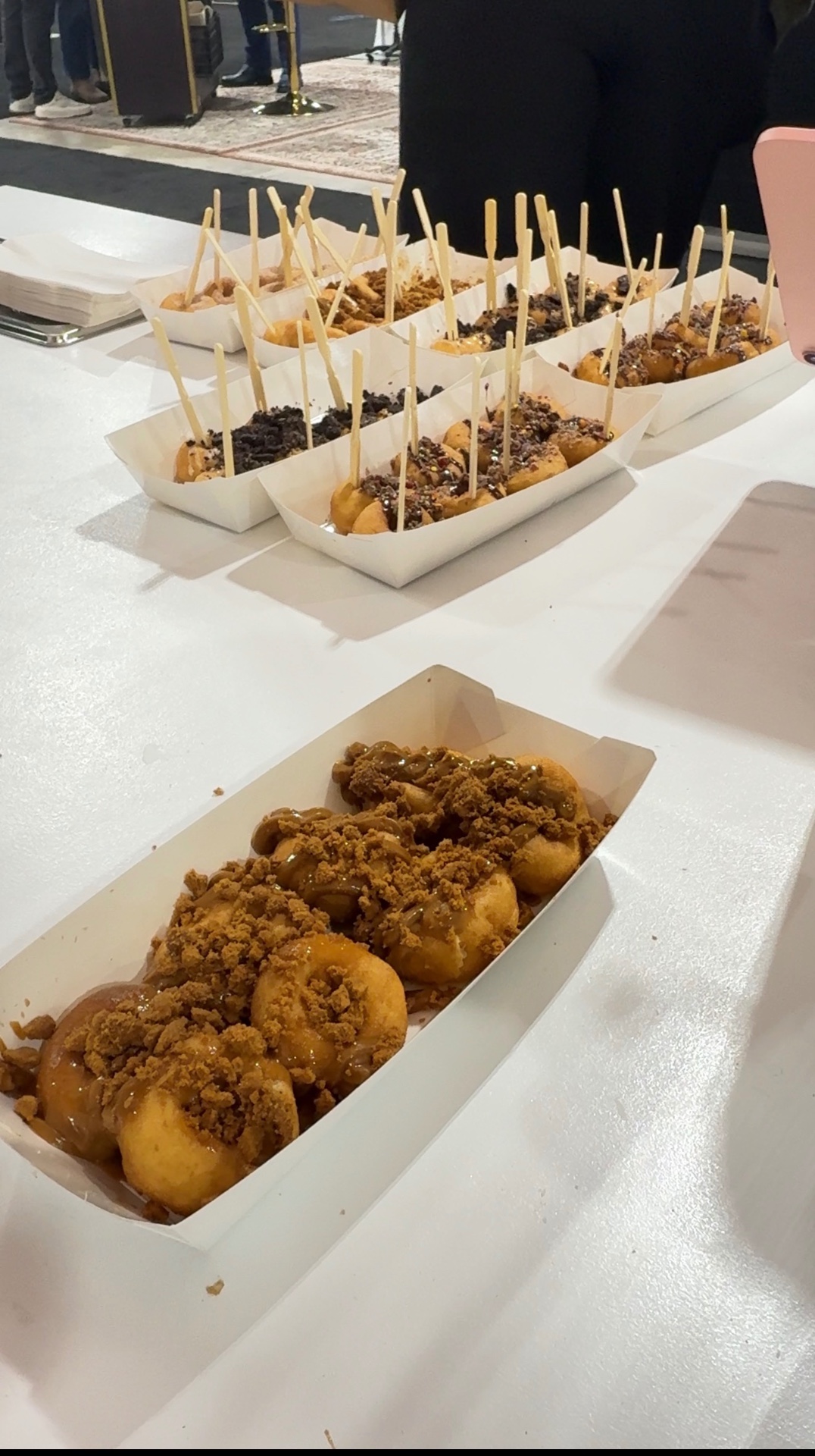 Assorted trays of mini doughnuts ready for guests