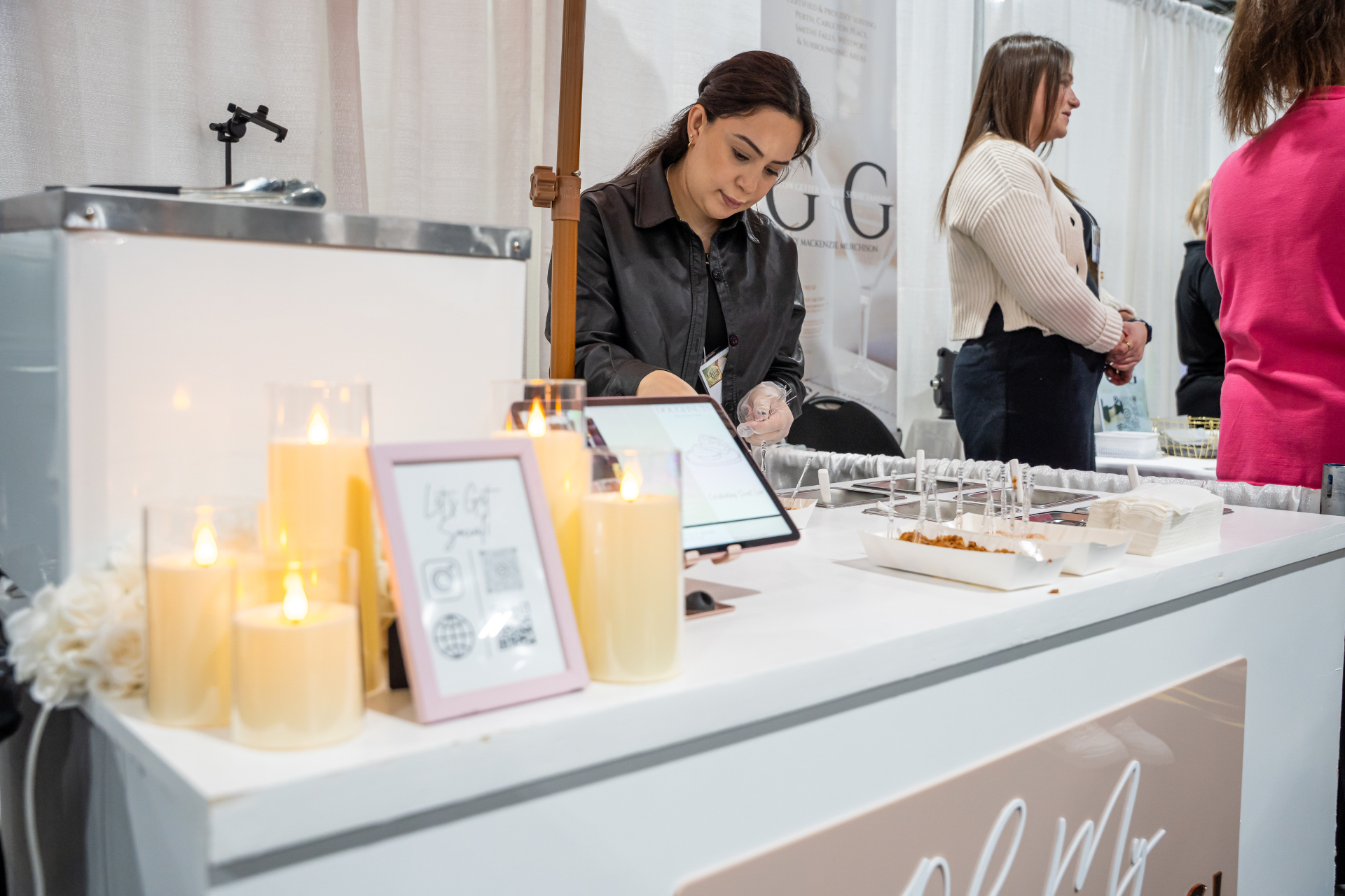 Doughnut booth lit with candles at an evening reception